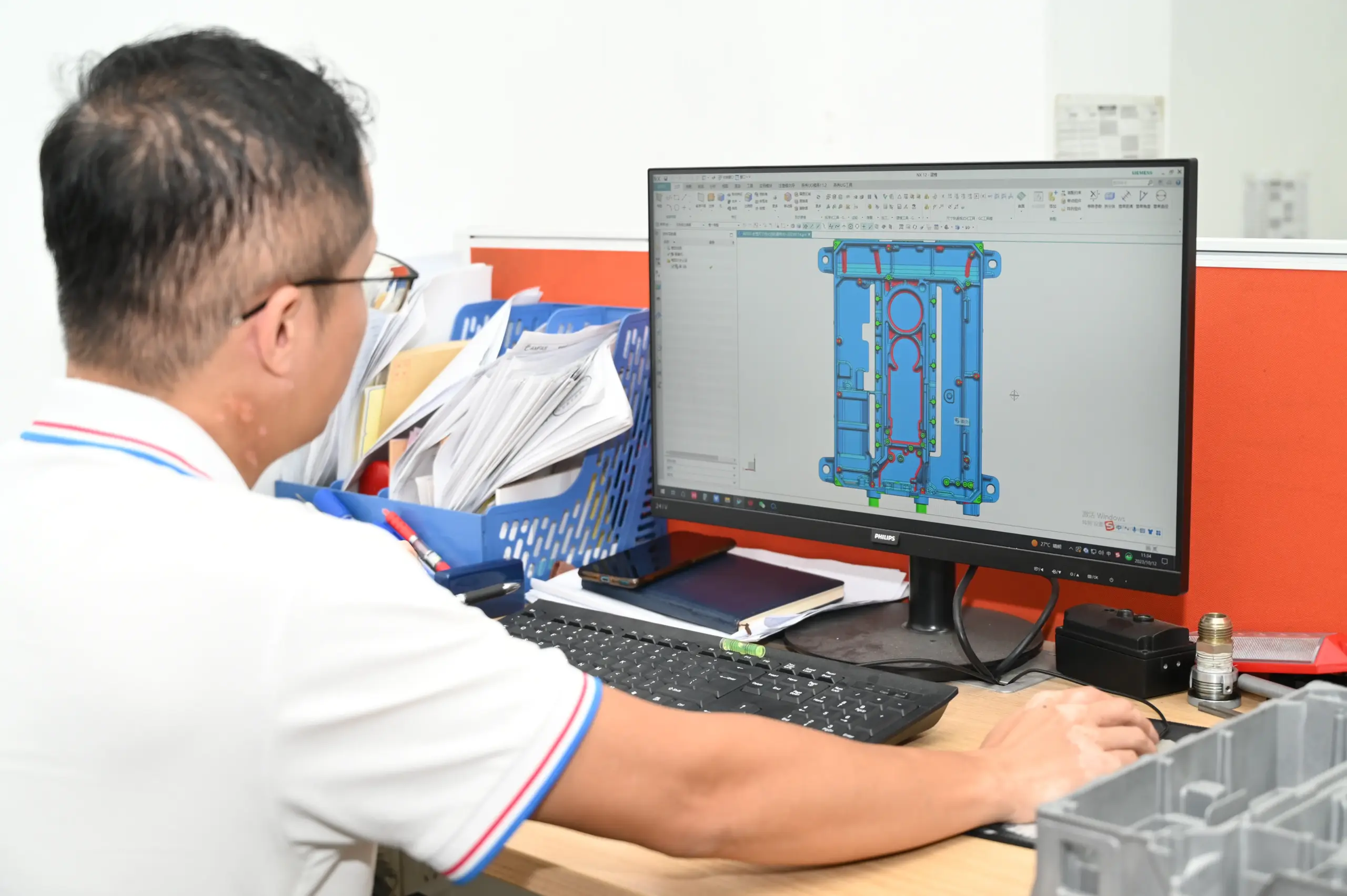 Die design engineer working on mold CAD layout for a die casting program