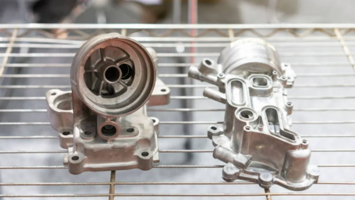 As-cast aluminum components cooling on a rack after casting