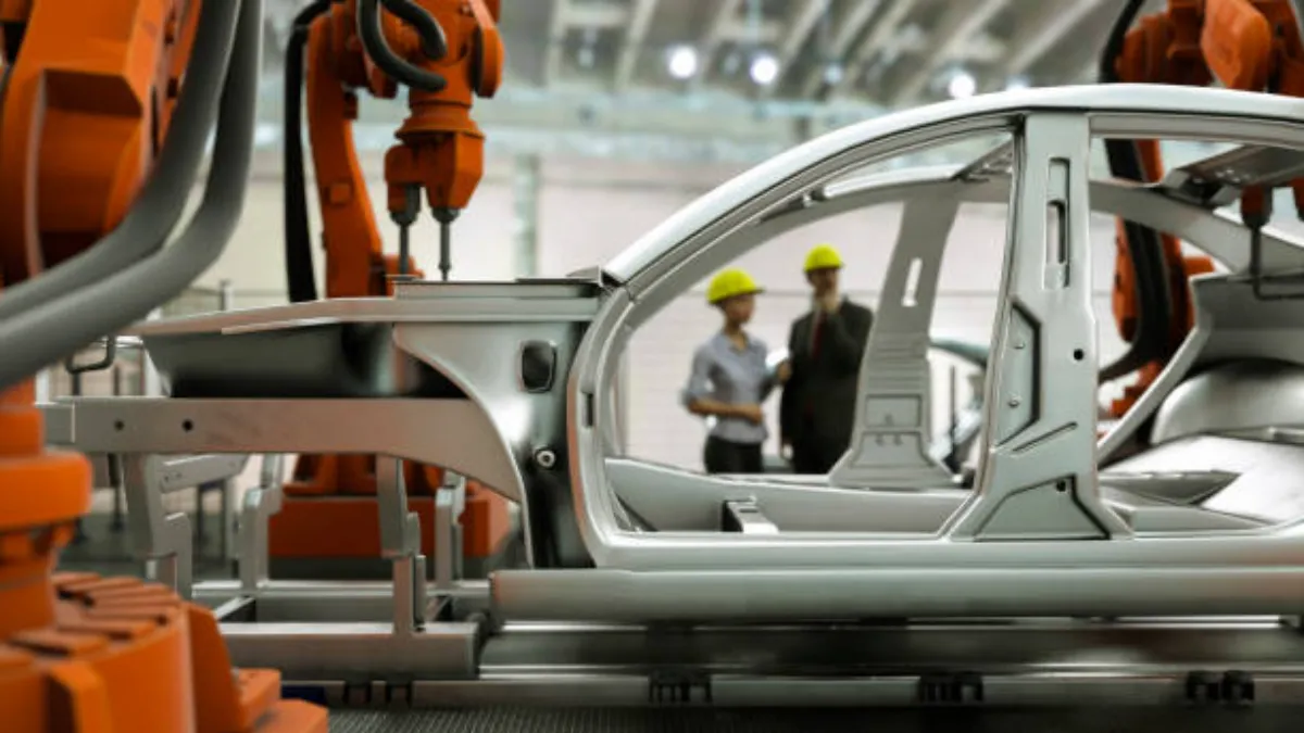 Aluminum die cast body structure positioned among robots on an automotive assembly line