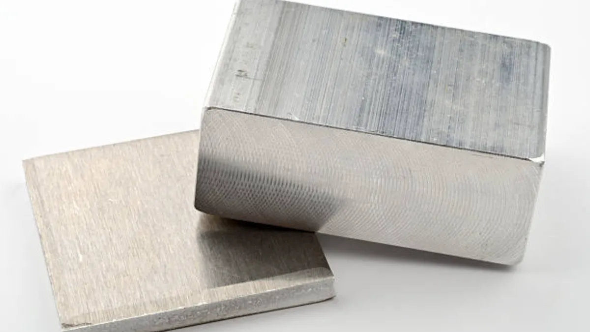 Two machined zinc alloy material blocks prepared for incoming chemistry verification