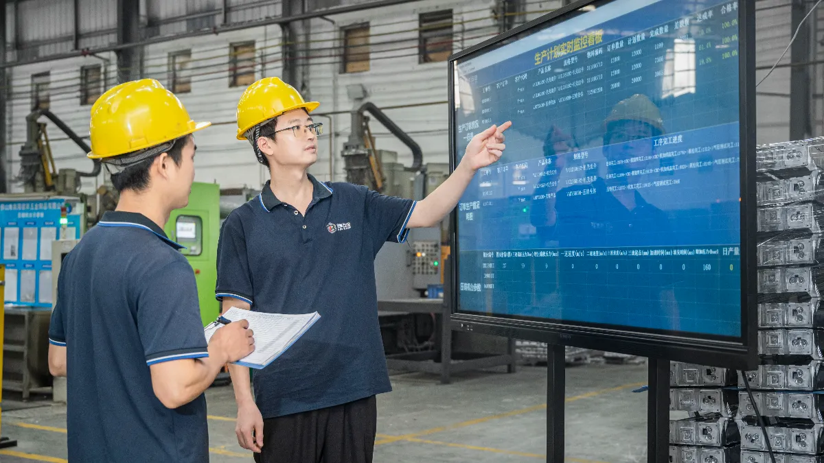 Engineers reviewing melt chemistry documents in a die casting factory