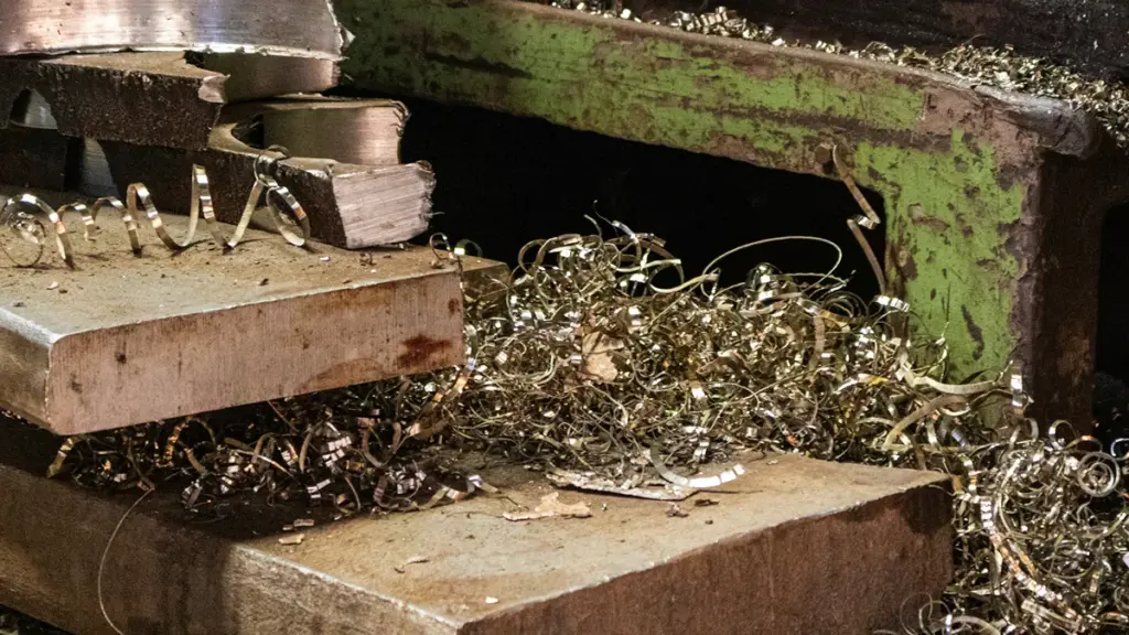 Industrial metal cutting machine producing curled metal shavings during machining